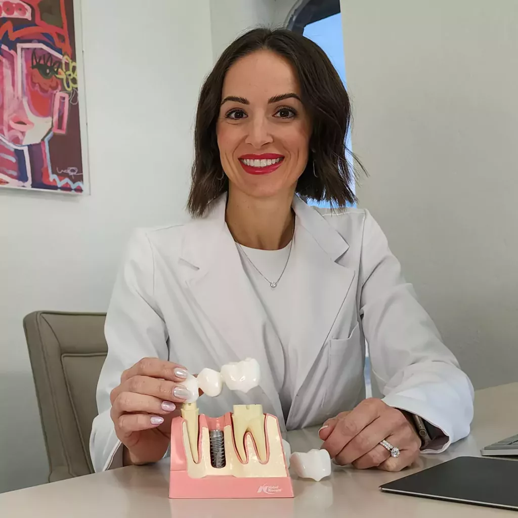 Dr. Traci Leon with a restorative dentistry model.
