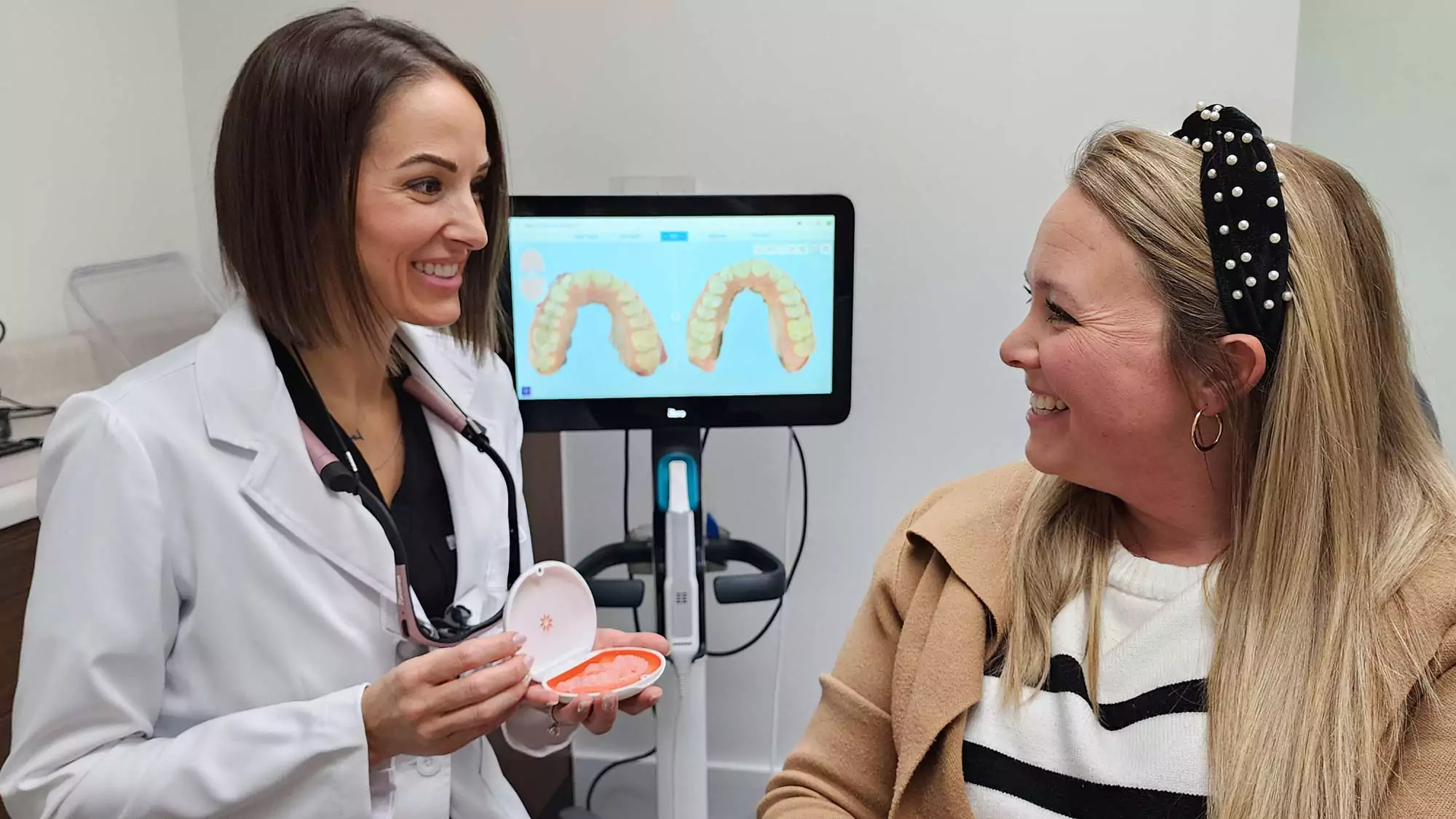 Dr. Traci Leon with an Invisalign® dental client.